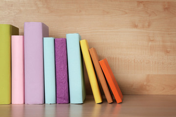 Books on wooden shelf close-up