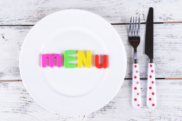 Inscription menu on plate on table close-up