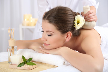 Obraz na płótnie Canvas Beautiful young woman having massage in spa salon