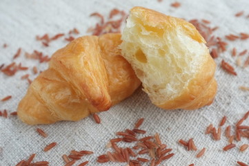 Croissants and Rice on Fabric background