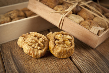Dried figs with walnuts concept with wooden table