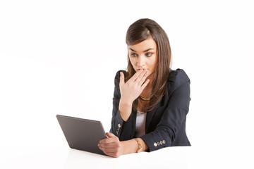 Young business woman working on tablet.