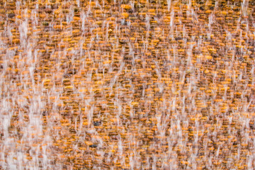 Flowing water over stone wall