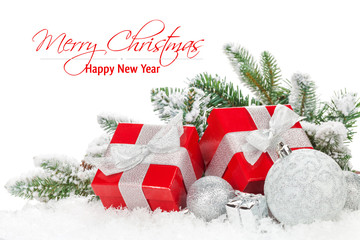 Christmas baubles and red gift boxes with snow fir tree