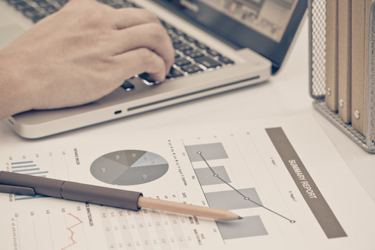 Businessman analyzing investment charts with laptop. Accounting