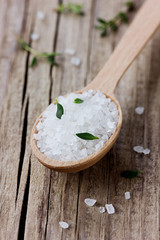 Obraz na płótnie Canvas Sea salt in spoon with a fresh herbs thyme