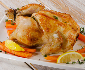 Roasted chicken  on   wooden board.