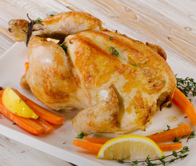 whole roasted chicken  on   wooden board.