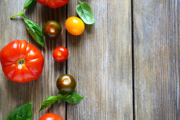 wooden background with ripe tomatoes