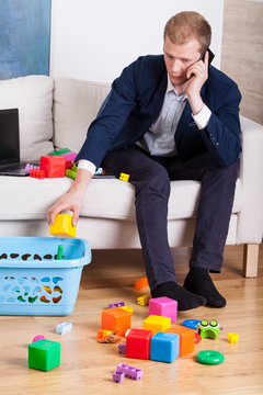 Elegant Man Cleaning Up Toys