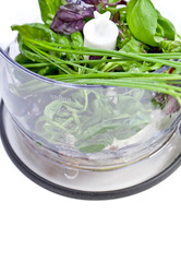 Blender with fresh vegetables and herbs