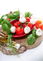Mozzarella cheese with cherry tomatoes and basil