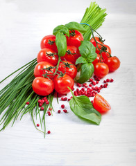 Tomatoes, chives, peppers, herbs on white