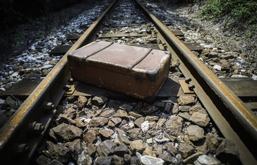 Vintage suitcase on railway road