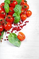 Tomatoes, chives, peppers, herbs on white