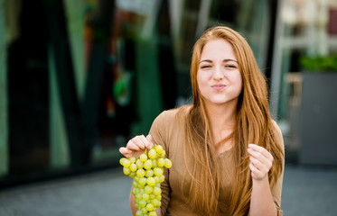 Teenager eating grapes