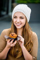 Teenager eating  muffin
