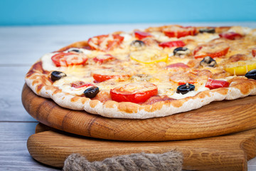 Delicious fresh pizza served on wooden table