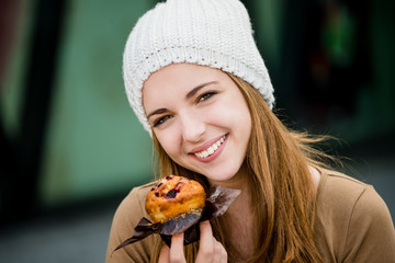Teenager eating  muffin