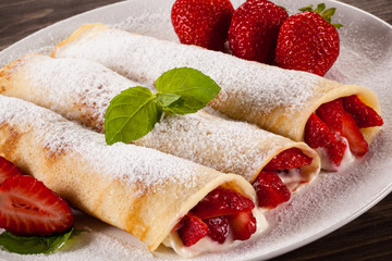 Pancakes with cream and strawberries