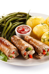 Wrapped pork chop, boiled potatoes and vegetables