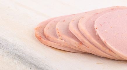 Sliced vegetarian bologna sausage on cutting board © Dourleak