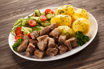 Grilled meat with boiled potatoes and vegetables