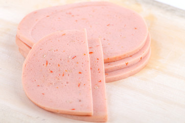 baloney sausage slices isolated on white