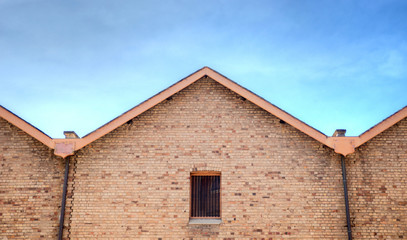 Old brick building with steel bars in window