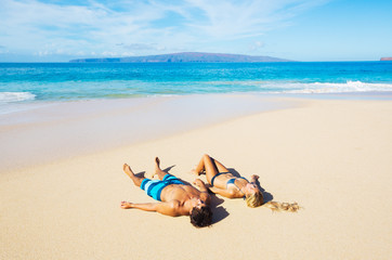 Fototapeta na wymiar Couple Relaxing on the Beach