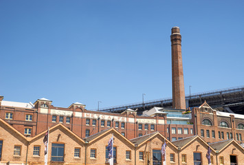Fototapeta premium Vintage brick Metcalfe Bond building and chimney with Sydney Har