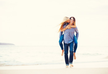 Romantic Young Couple Walking on the Beach