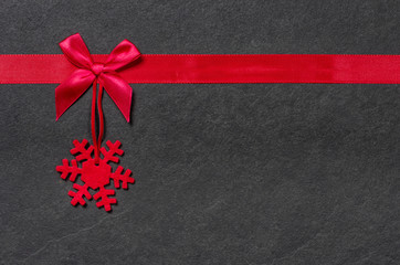 Weihnachtlicher Filzanhänger mit Schleife auf Schiefer