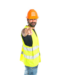 Workman pointing to the front over white background