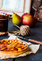 round apple tart with pear jam and caramel, vertically