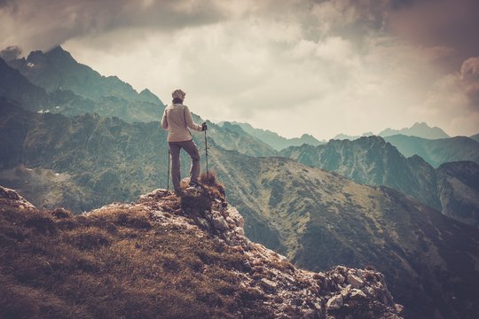 Woman Hiker On A Top Of A Mountain