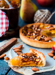 apple tart on a sand base with caramel on parchment