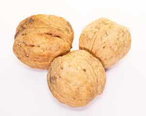 Three dried walnuts isolated on white background