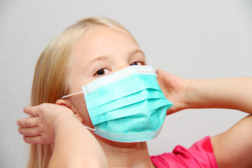 Little girl wearing a protective mask