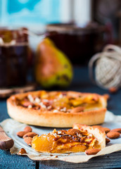 apple tart on a sand base with caramel on parchment