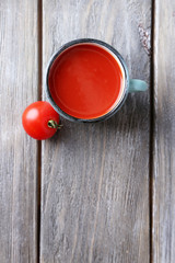 Homemade tomato juice in color mug and fresh tomatoes