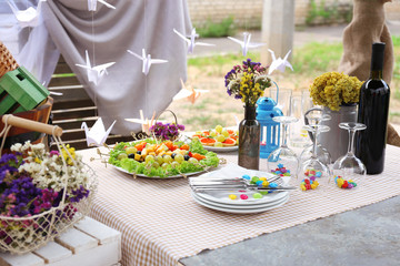 Buffet table with dishware waiting for guests