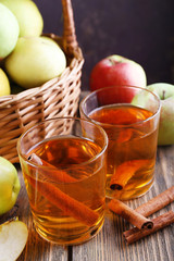 still life with apple cider and fresh apples on wooden table