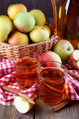 still life with apple cider and fresh apples on wooden table