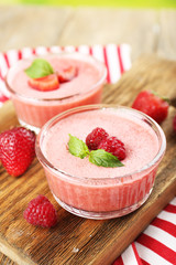 Delicious berry mousse in bowls on table close-up