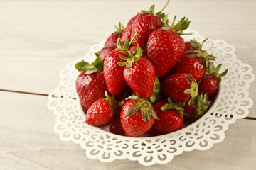 Juicy fresh ripe red strawberries on white plate