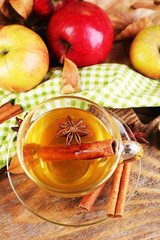 Composition of  apple cider with cinnamon sticks, fresh apples
