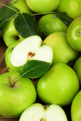 Ripe green apples on wooden background