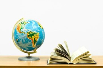 exposed book and globe