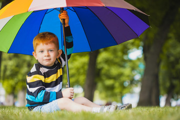 little boy lying on grass in the park